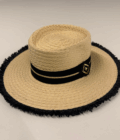 Paperstraw hat with black ribbon and gold embellishment